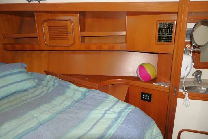 Slide: The Image of Cozy cabin interior of 2002 Tayana 460 Vancouver Pilothouse with bed and wooden shelves. - 39