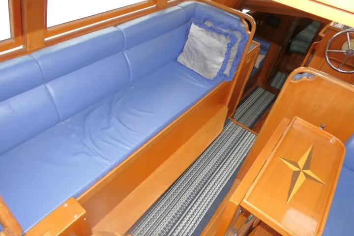 Slide: The Image of Interior of 2002 Tayana 460 Vancouver Pilothouse with blue seating and wooden accents. - 4