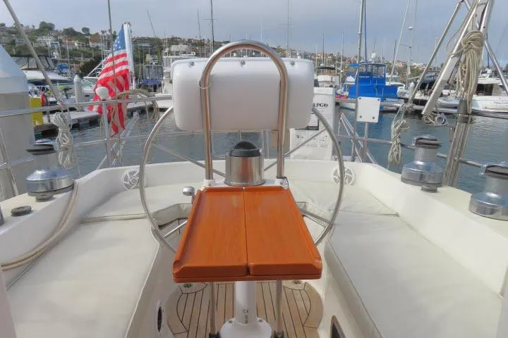 Slide: The Image of Tayana 460 Vancouver Pilothouse 2002 yacht cockpit with steering wheel and marina view. - 47