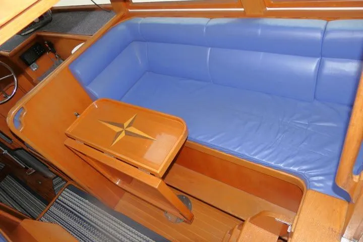Slide: The Image of Interior of 2002 Tayana 460 Vancouver Pilothouse with blue seating and wooden table. - 5
