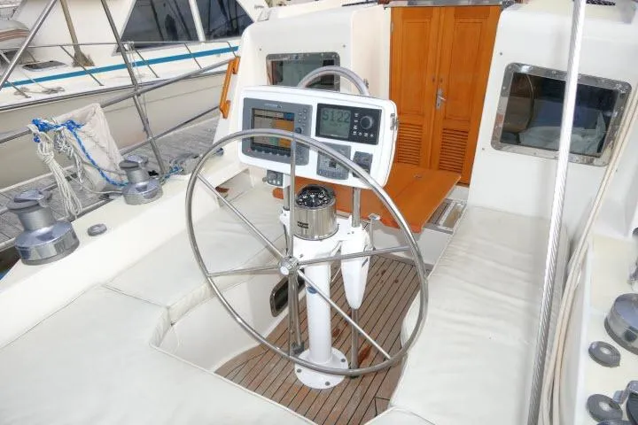 Slide: The Image of 2002 Tayana 460 Vancouver Pilothouse yacht cockpit with steering wheel and navigation instruments. - 51