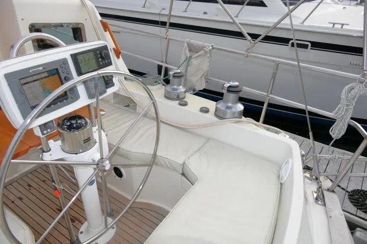 Slide: The Image of Cockpit of 2002 Tayana 460 Vancouver Pilothouse with navigation equipment and steering wheel. - 55