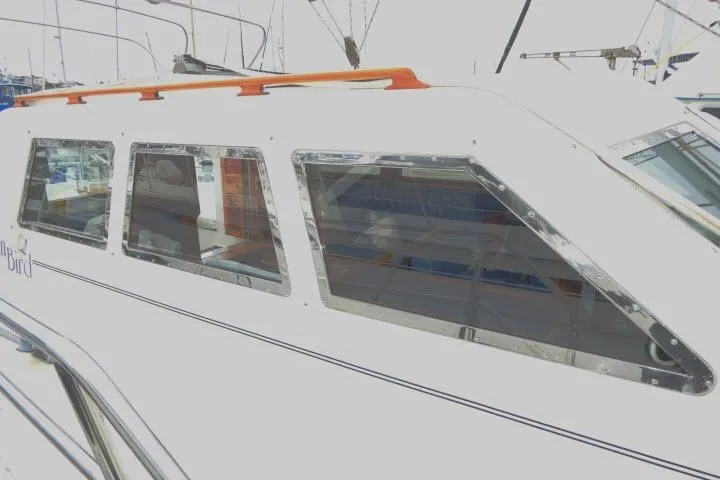 Slide: The Image of 2002 Tayana 460 Vancouver Pilothouse yacht with sleek windows and orange railings. - 58
