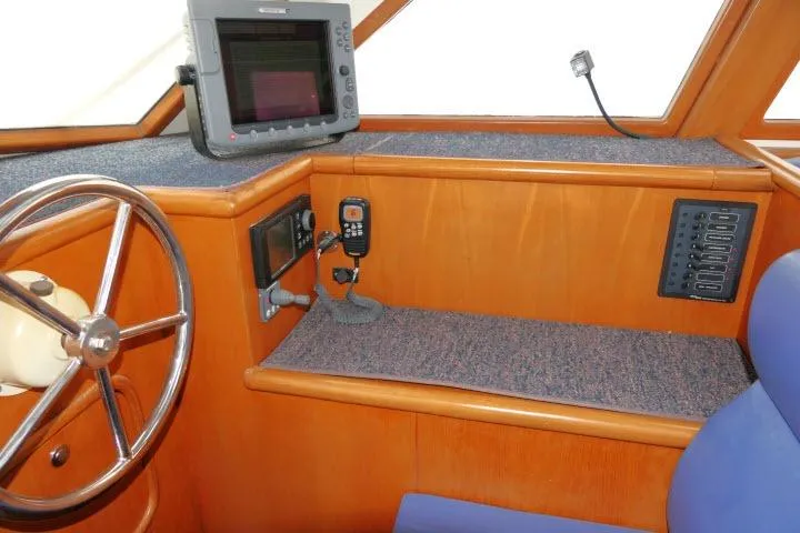 Slide: The Image of Pilothouse interior of 2002 Tayana 460 Vancouver, featuring navigation equipment and wooden finish. - 7