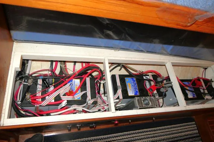 Slide: The Image of Battery compartment of 2002 Tayana 460 Vancouver Pilothouse with wiring and connections. - 75
