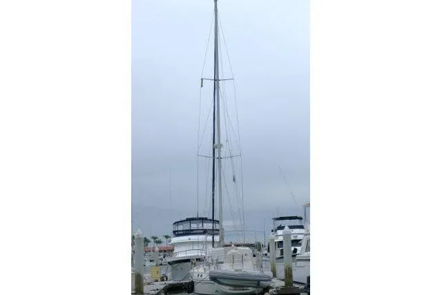 Slide: The Image of 2002 Tayana 460 Vancouver Pilothouse sailboat docked at a marina under cloudy skies. - 81
