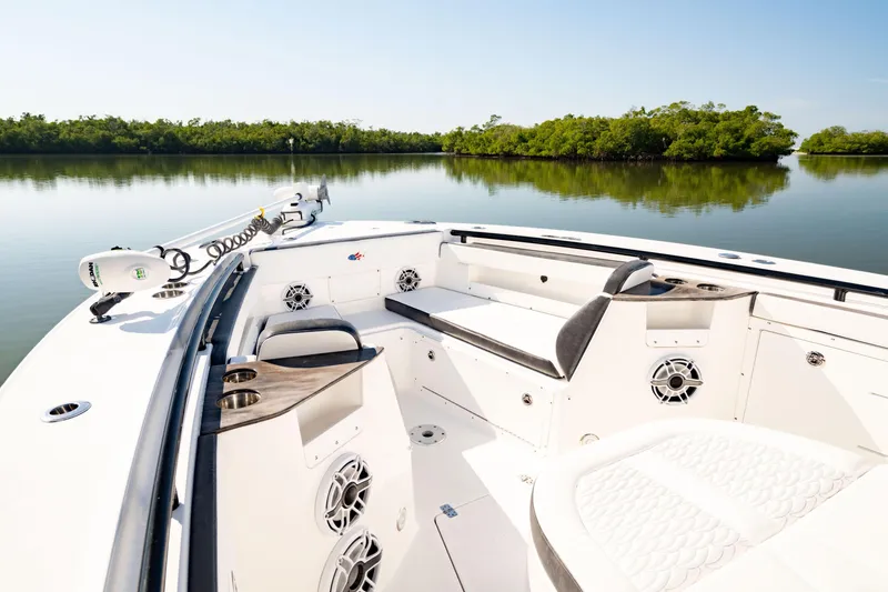 Slide: The Image of 2022 Crevalle 33 CSF boat interior with seating, speakers, and calm water view. - 14
