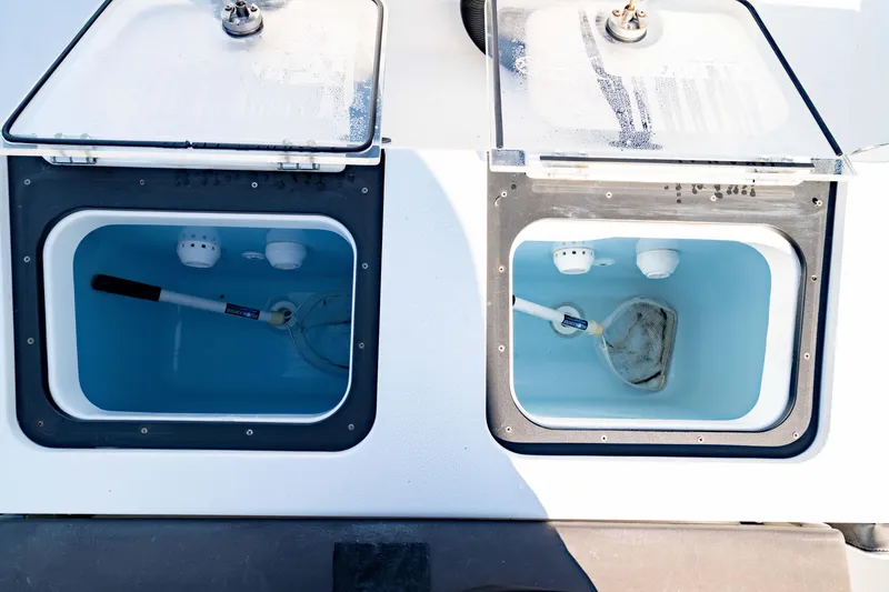 Slide: The Image of 2022 Crevalle 33 CSF livewell compartments with nets and water. - 16