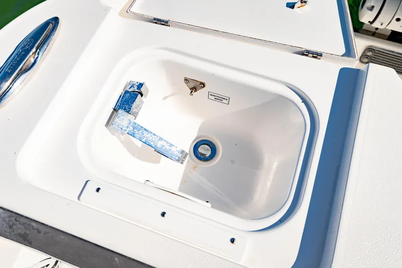 Slide: The Image of Livewell compartment on 2022 Crevalle 33 CSF boat, featuring non-potable water label. - 17