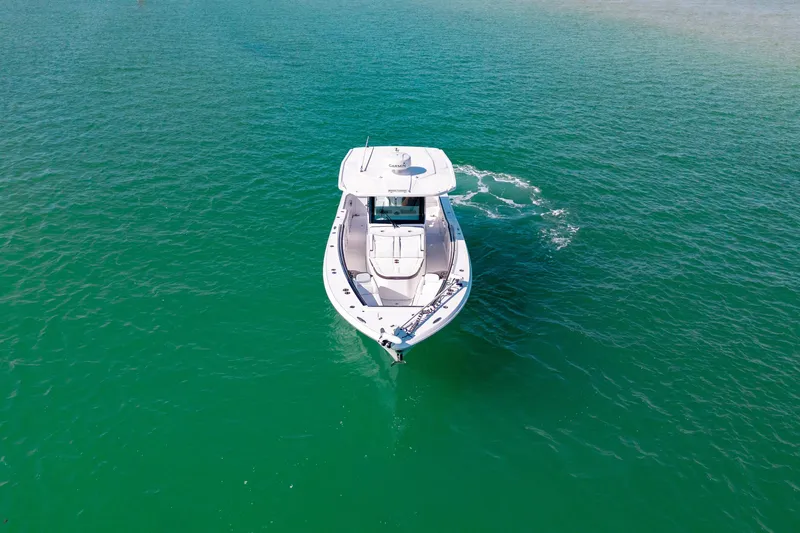 Slide: The Image of 2022 Crevalle 33 CSF boat cruising on clear turquoise water. - 24