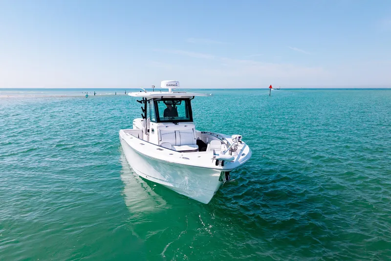Slide: The Image of 2022 Crevalle 33 CSF boat on clear turquoise water under blue sky. - 25