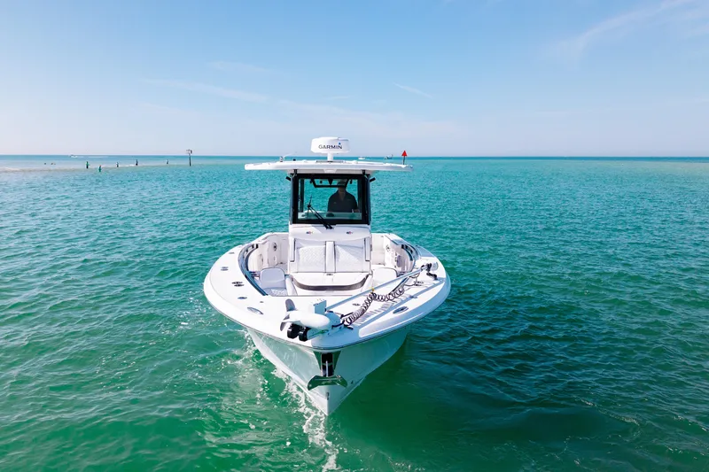 Slide: The Image of 2022 Crevalle 33 CSF boat on clear turquoise water under blue sky. - 26