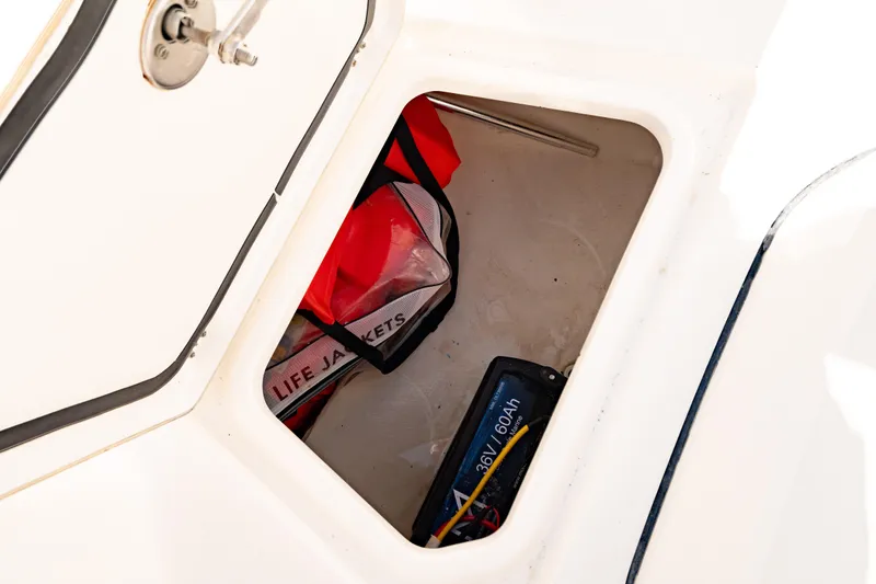 Slide: The Image of Storage compartment in 2022 Crevalle 33 CSF boat with life jackets and battery. - 29