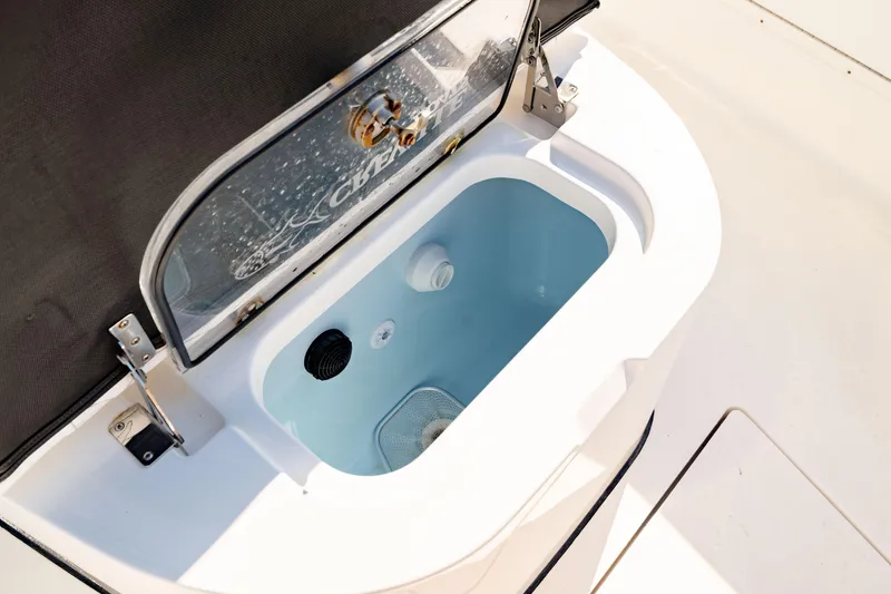 Slide: The Image of Livewell on 2022 Crevalle 33 CSF boat, open lid, clean interior. - 31