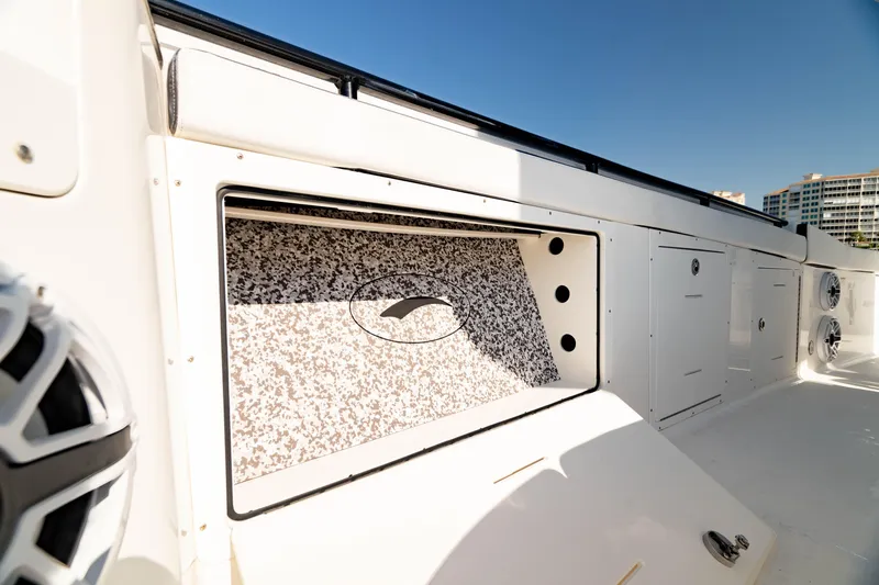 Slide: The Image of 2022 Crevalle 33 CSF boat interior with storage compartments and speakers. - 34