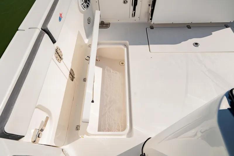 Slide: The Image of 2022 Crevalle 33 CSF boat deck with open storage compartment. - 38