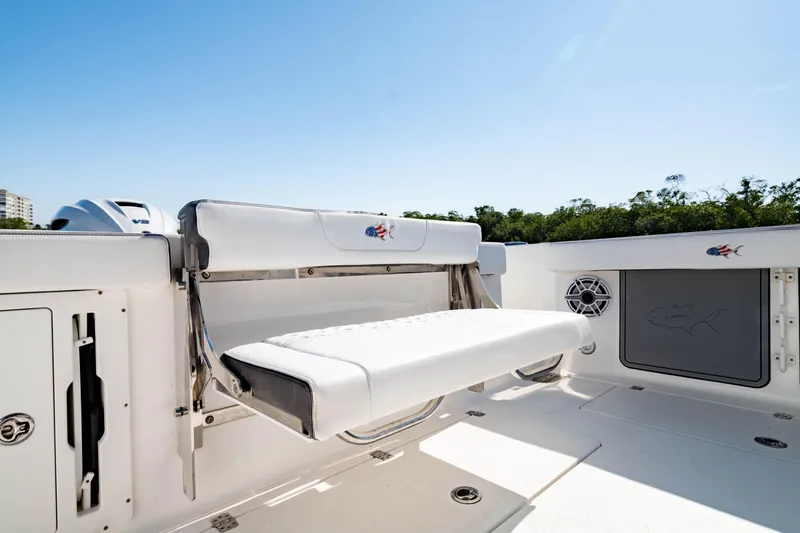 Slide: The Image of 2022 Crevalle 33 CSF boat with white seating and speaker, sunny day. - 47