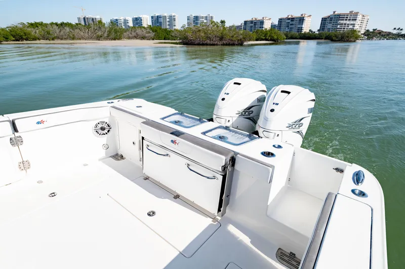 Slide: The Image of 2022 Crevalle 33 CSF boat with dual Yamaha engines on calm water. - 48