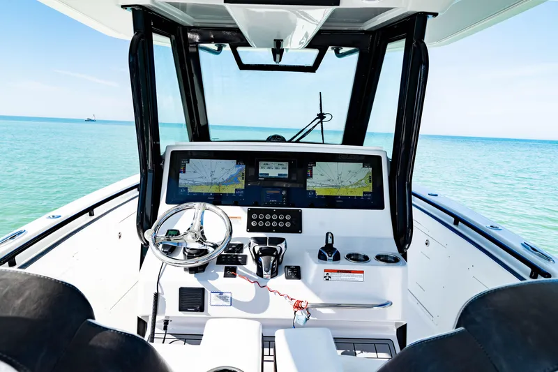 Slide: The Image of 2022 Crevalle 33 CSF boat cockpit with navigation screens and ocean view. - 5