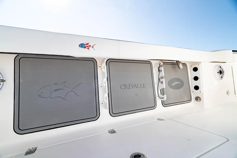 Slide: The Image of 2022 Crevalle 33 CSF boat interior with storage compartments and speaker. - 50