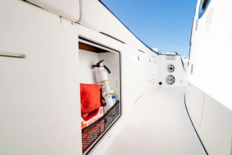 Slide: The Image of 2022 Crevalle 33 CSF boat storage with safety equipment and speakers. - 52