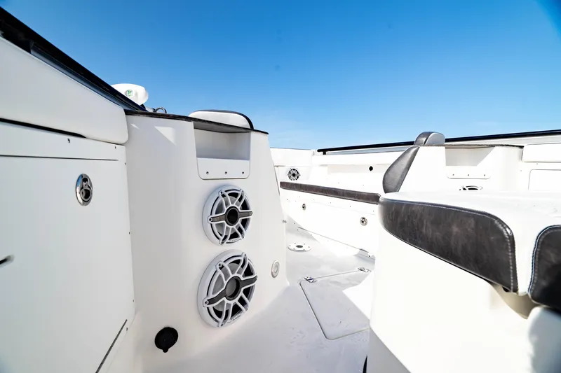 Slide: The Image of 2022 Crevalle 33 CSF boat interior with speakers and seating under clear blue sky. - 55