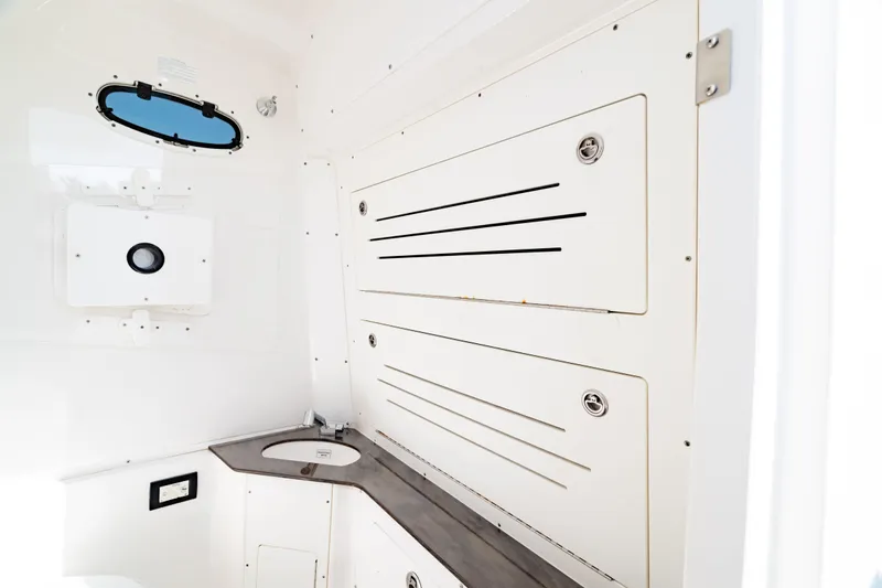Slide: The Image of 2022 Crevalle 33 CSF boat interior with storage compartments and sink. - 57