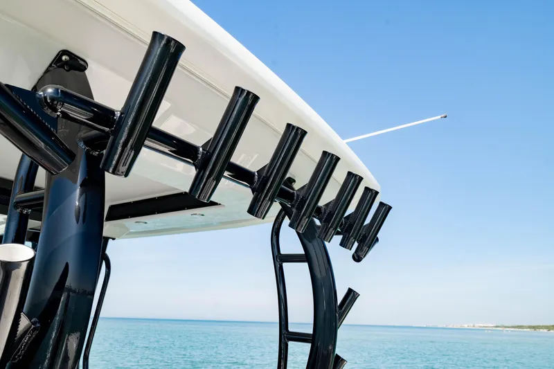 Slide: The Image of 2022 Crevalle 33 CSF boat with rod holders against a clear blue sky. - 63