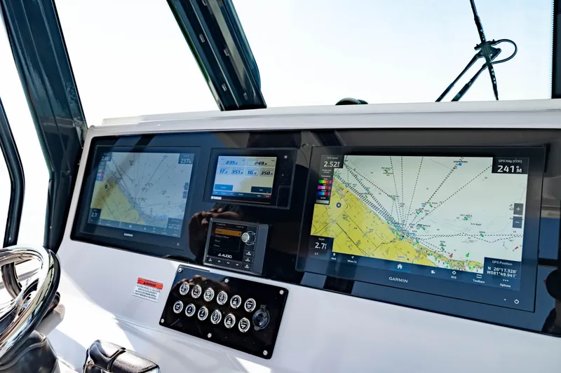 Slide: The Image of Crevalle 33 CSF 2022 boat dashboard with navigation screens and controls. - 64