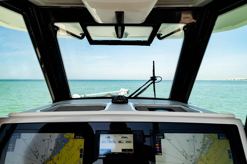 Slide: The Image of 2022 Crevalle 33 CSF boat cockpit with navigation screens and ocean view. - 73