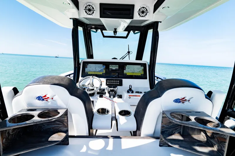 Slide: The Image of Interior of 2022 Crevalle 33 CSF boat with dual navigation screens and ocean view. - 77