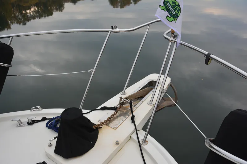 Slide: The Image of Bow of 1988 Camargue 48 Cockpit Motor Yacht with anchor chain and flag. - 12