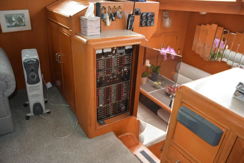 Slide: The Image of 1988 Camargue 48 Cockpit Motor Yacht helm with wooden steering wheel and control panel. - 19