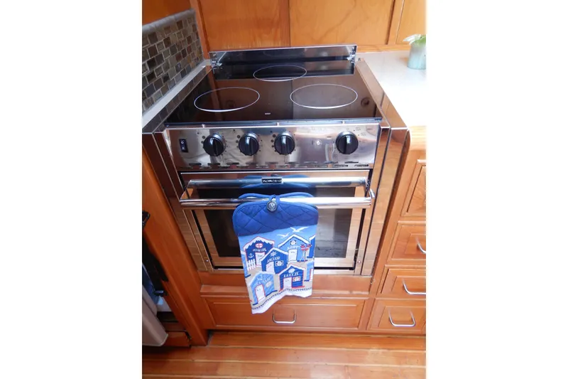 Slide: The Image of Interior of 1988 Camargue 48 Cockpit Motor Yacht with dining area and cushioned seating. - 27