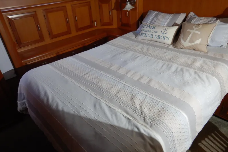 Slide: The Image of Cozy bedroom in 1988 Camargue 48 Cockpit Motor Yacht with nautical-themed pillows. - 38