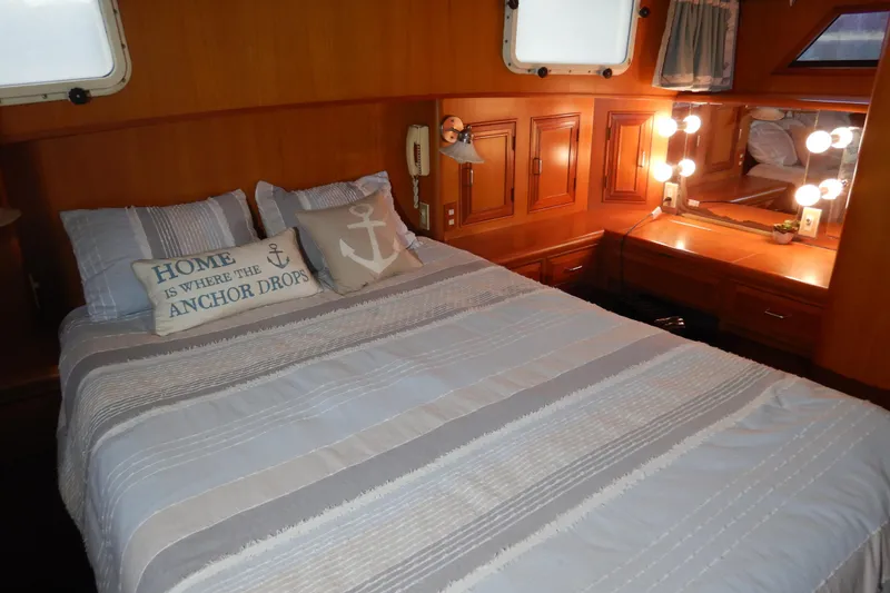 Slide: The Image of Cozy bedroom in 1988 Camargue 48 Cockpit Motor Yacht with nautical decor and vanity. - 39