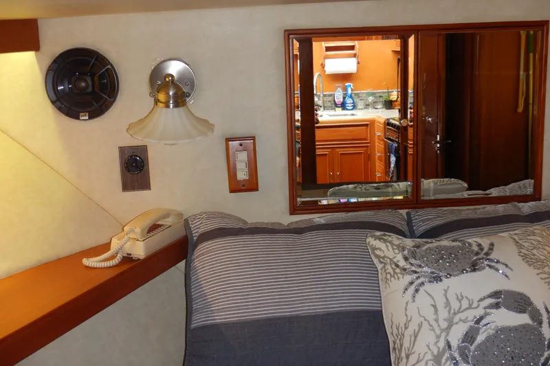 Slide: The Image of Interior of 1988 Camargue 48 Yacht with bed, phone, and kitchen view. - 42