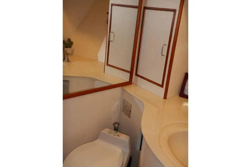 Slide: The Image of Bathroom interior of 1988 Camargue 48 Cockpit Motor Yacht with sink and mirror. - 44