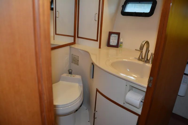 Slide: The Image of 1988 Camargue 48 Cockpit Motor Yacht bathroom with sink, toilet, and mirror. - 45