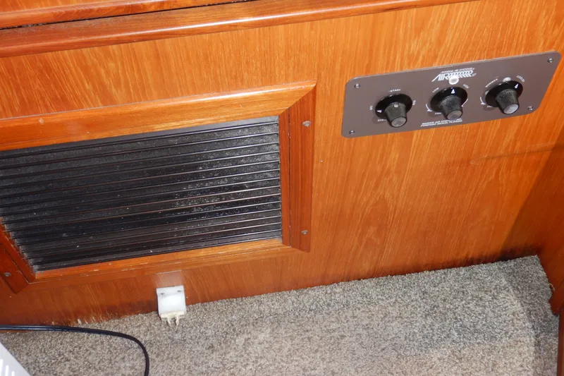 Slide: The Image of 1988 Camargue 48 Cockpit Motor Yacht interior with control panel and vent. - 49