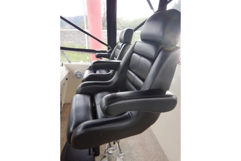 Slide: The Image of 1988 Camargue 48 Cockpit Motor Yacht helm with navigation equipment and steering wheel. - 52