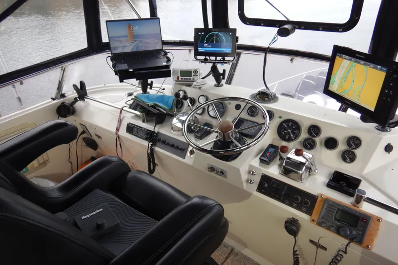 Slide: The Image of Interior view of 1988 Camargue 48 Cockpit Motor Yacht with rain-speckled windows. - 53