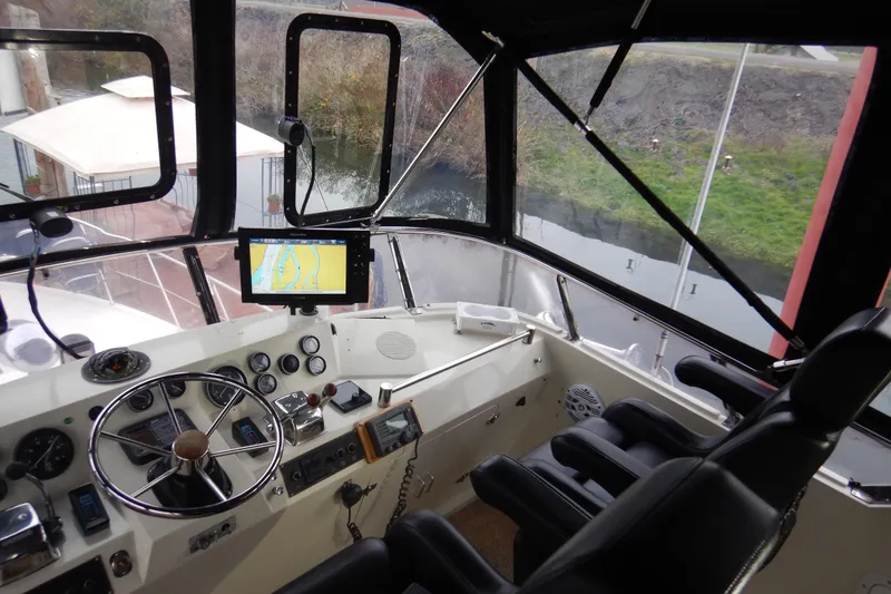 Slide: The Image of Cockpit of 1988 Camargue 48 Motor Yacht with navigation equipment and controls. - 54