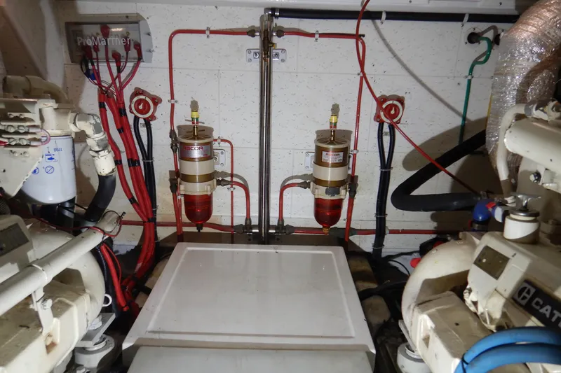 Slide: The Image of Engine compartment of 1988 Camargue 48 Cockpit Motor Yacht, featuring CAT engine details. - 68