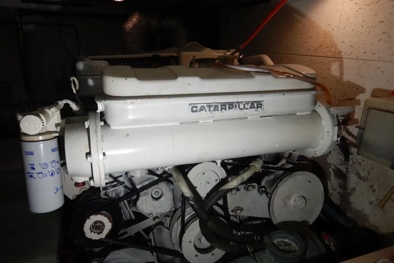Slide: The Image of Engine compartment of a 1988 Camargue 48 Cockpit Motor Yacht, featuring hoses and components. - 69