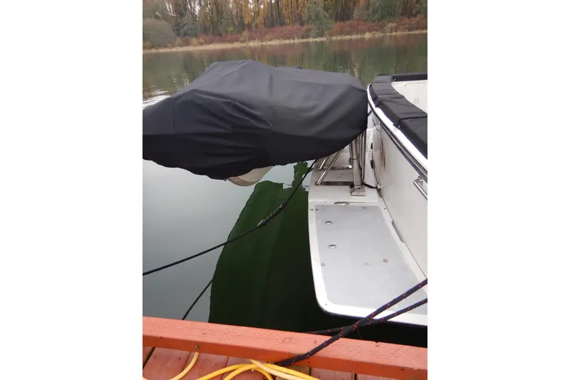 Slide: The Image of 1988 Camargue 48 Cockpit Motor Yacht docked, covered, with calm water reflection. - 7