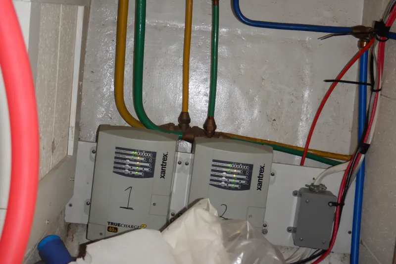 Slide: The Image of Battery compartment of a 1988 Camargue 48 Cockpit Motor Yacht with wiring connections. - 70