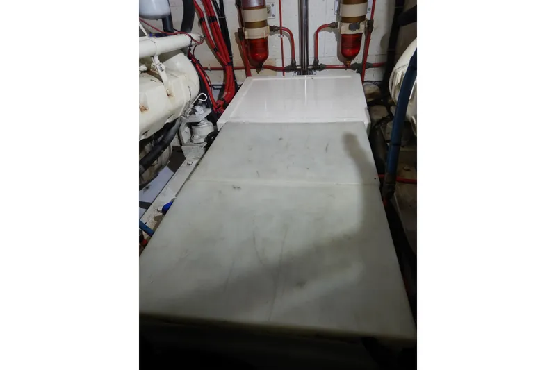 Slide: The Image of Engine room of 1988 Camargue 48 Cockpit Motor Yacht with visible wiring and components. - 74