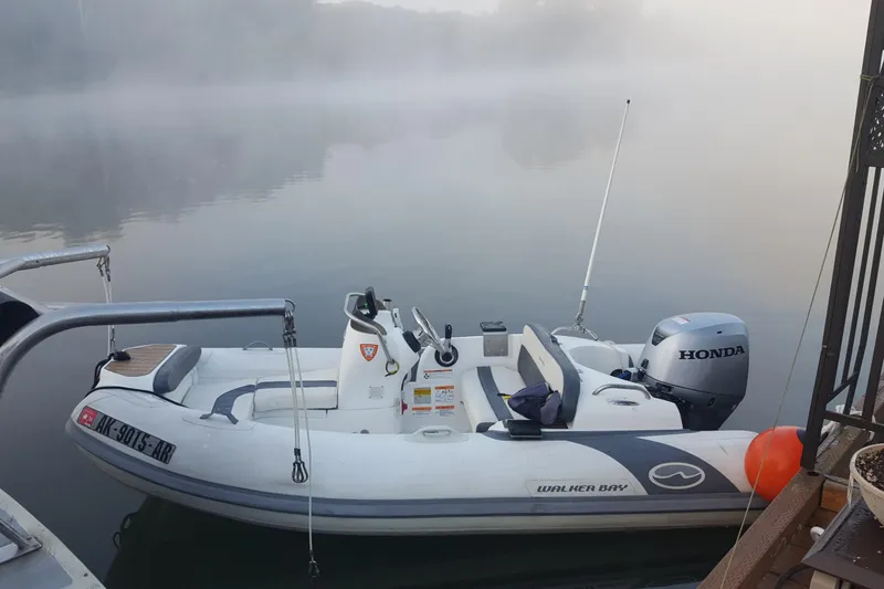 Slide: The Image of Inflatable boat with Honda motor on misty water, near Camargue 48 Cockpit Motor Yacht, 1988. - 8