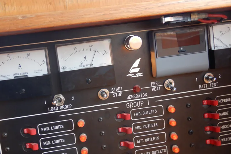 Slide: The Image of Binders labeled "Alaskan Sea-Duction" with vessel documentation on a yacht's interior table. - 81